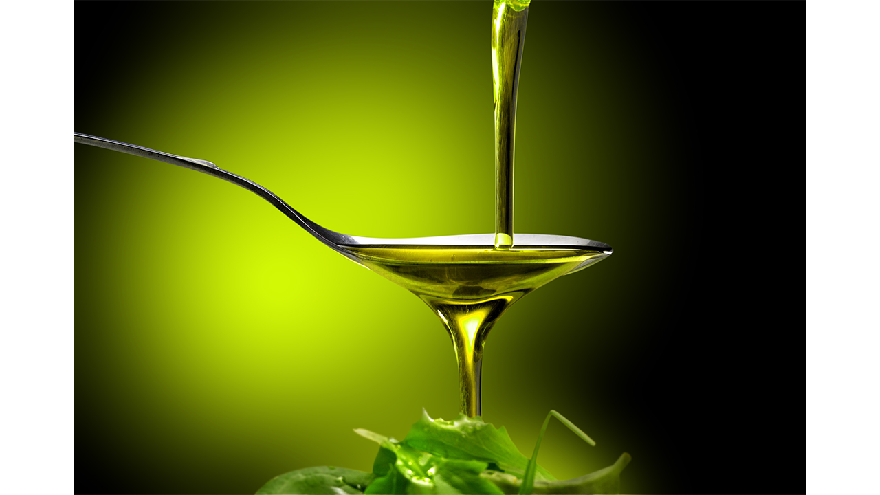 image of olive oil being poured into a spoon