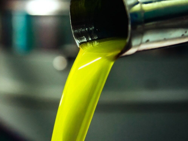 Green olive oil being poured; image from Selina Wang